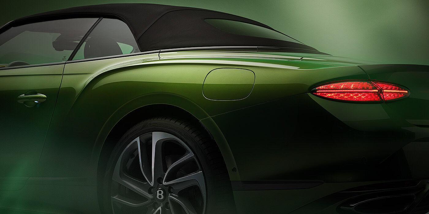 Bentley Bordeaux Bentley New Continental GTC Speed rear haunch and tail lamp in Tourmaline Green paint and dark tint brightware with black hood up and illuminated head lamps