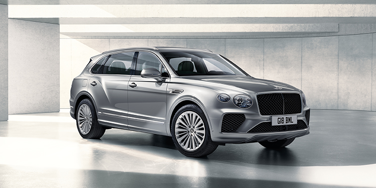 Bentley Bordeaux Bentley Bentayga Extended Wheelbase SUV front three quarter in Moonbeam paint with a grey background